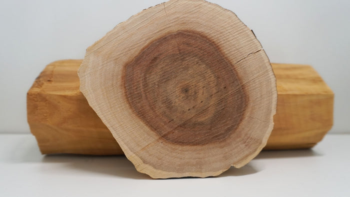 Cut wood showing natural grain, evoking woody fragrance notes