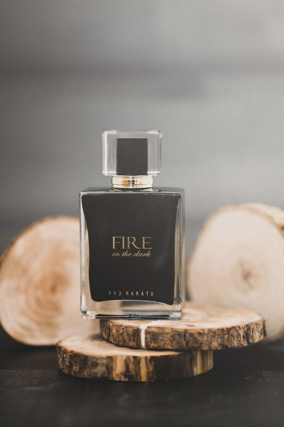 A warm amber perfume bottle on rustic wood, evoking autumn fragrances