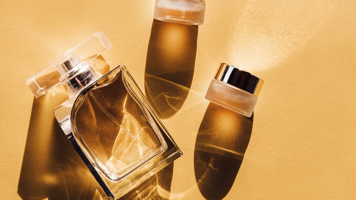 Two clear glass perfume bottles side by side