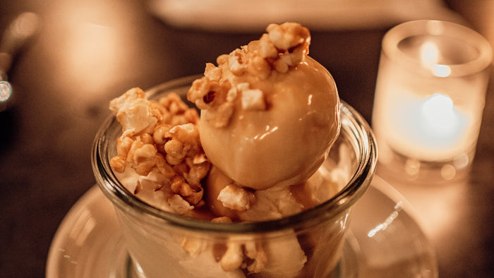 A glass bowl of vanilla ice cream